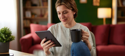 Smiling woman reading a tablet
